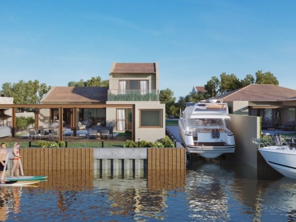 Casas tipo de frente para o canal, com lanchas atracadas e pessoas remando em pranchas, no Toriba (imagem ilustrativa)